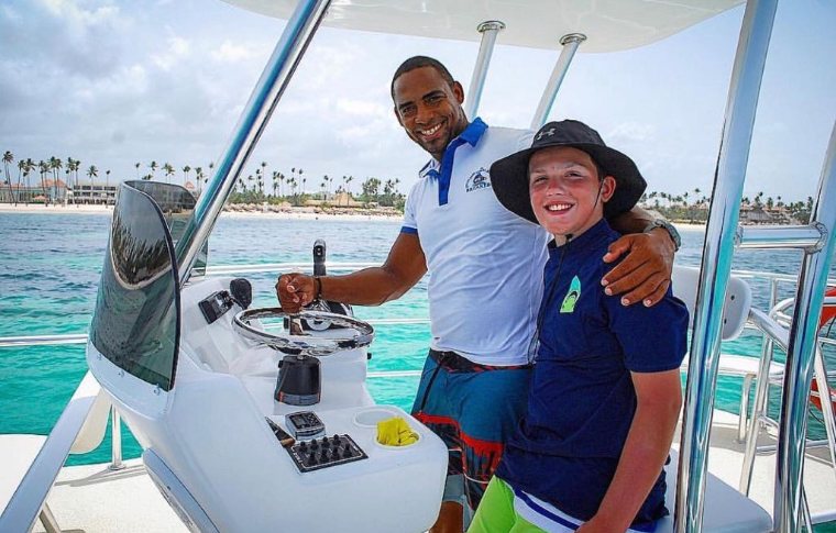 Smiling man and boy on boat in Punta Cana