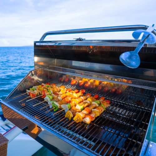 11 - Happy guest enjoy delicious BBQs on our private catamaran Delux for large groups tour-min