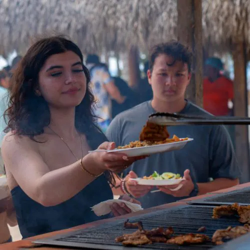 12 - Happy guest enjoy taste food on our catamaran Punta Cana isla saona tour