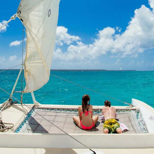 2 - Happy couple guest enjoy sunbath and see the views of Isla Soana on our Isla Soana catamaran tour