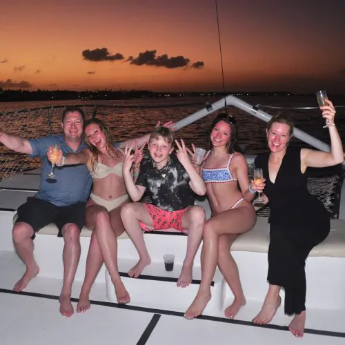 2 - Happy guest enjoy beautiful scene of sunset while enjoy drinks on our sunset cruise punta cana tour