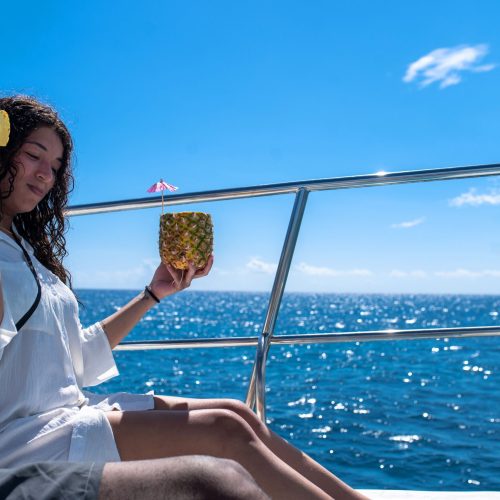 3 - Happy guest enjoy drinks and juices on our Isla Soana catamaran tour