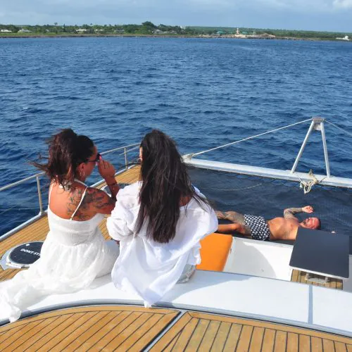 4 - Happy guests enjoy views and taking sunbath on our private yacht to Saona Island tour