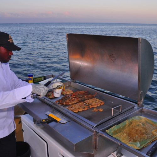 5 - Cheif preparing BBQ for our guest on sunset cruise punta cana tour