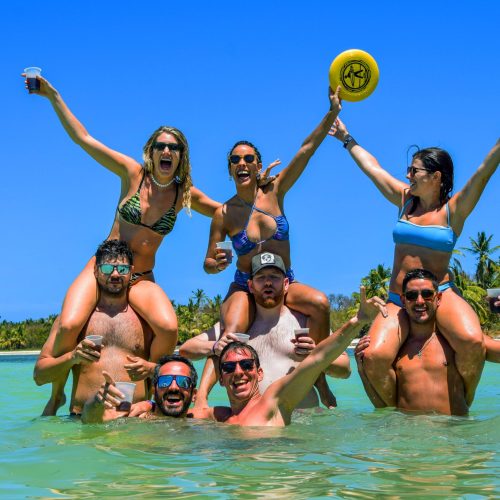 5 Happy guests group snorkeling and enjoying in Punta Cana crystal waters on our private catamaran Delux for large groups tour
