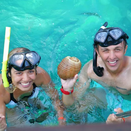 6 - Happy couple guests enjoying snorkeling and making lovely memories on our private catamaran Delux Punta Cana tour