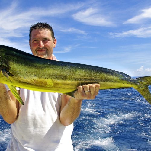 Another happy client catching a beautiful fish on deep sea fishing tour Punta Cana